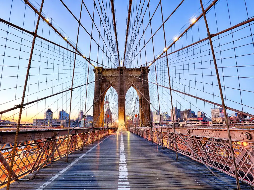 Puente de Brooklyn vacío en Nueva York con edificios en el fondo y con luces encendidas