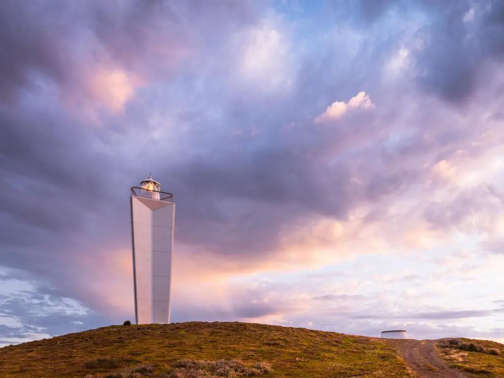 Cape Jervis, Australia del Sur, tomada al atardecer con vistas al faro moderno con nubes coloridas. 