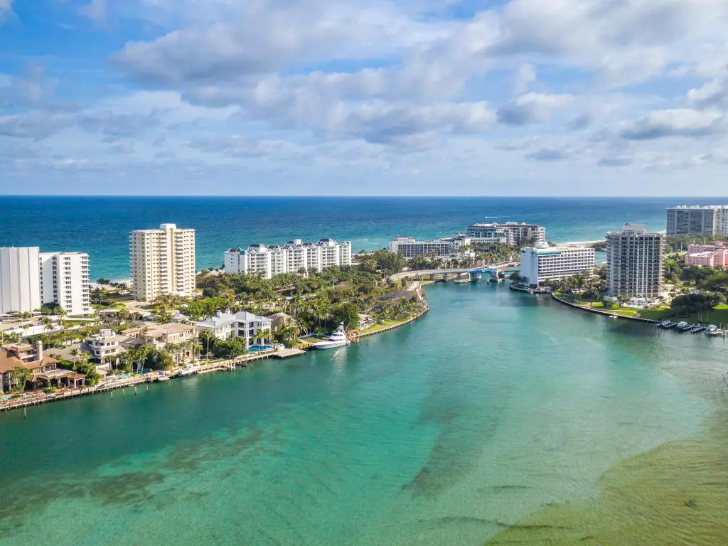 Boca Raton, Florida, EE.UU. tomada como una vista aérea del lago, los edificios de la ciudad y el mar más allá en un día soleado.