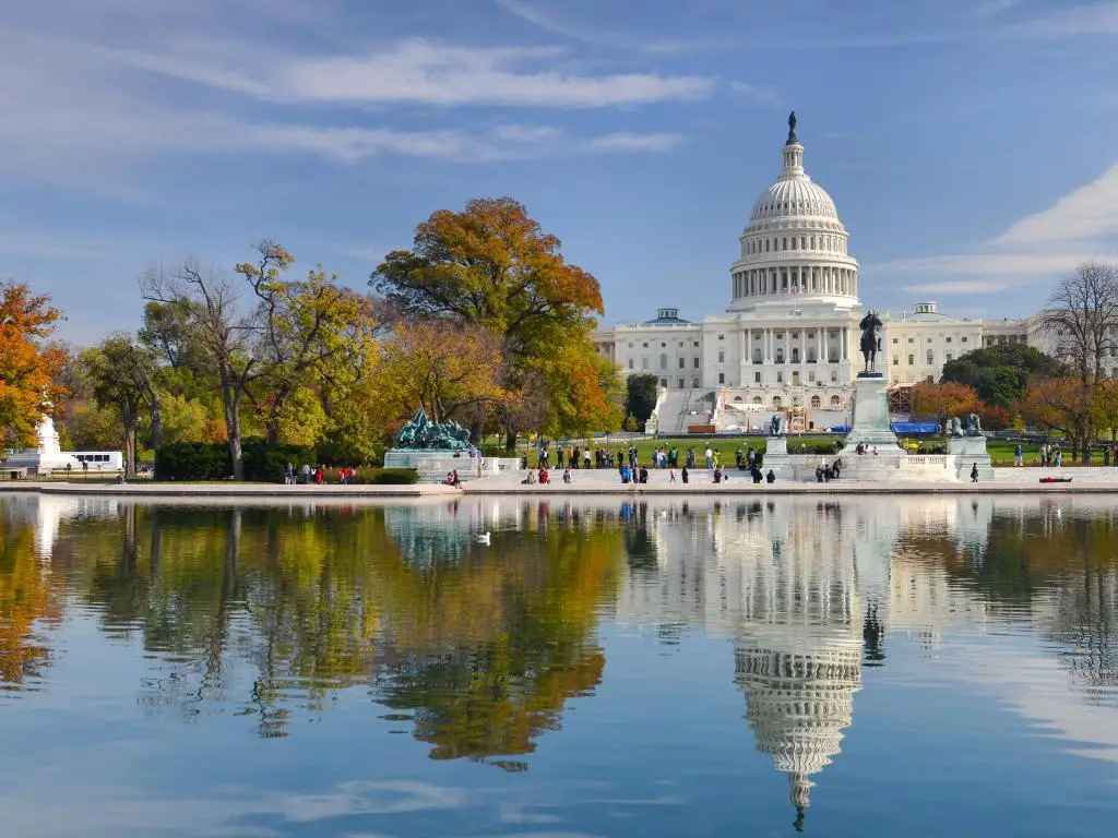 Washington DC, EE.UU. con el edificio del Capitolio de EE.UU. en otoño en el fondo reflejado en el agua en primer plano.