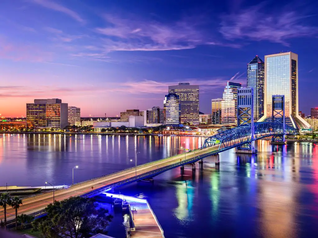 El centro de la ciudad de Jacksonville, Florida, EE.UU. se tomó de noche con el puente en primer plano. 