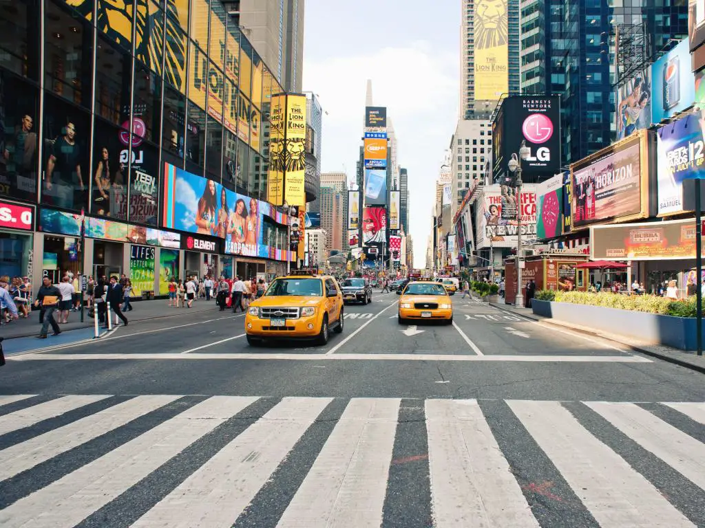 Ciudad de Nueva York, EE.UU. con taxis en Times Square, una concurrida intersección turística de anuncios comerciales y una calle famosa de la ciudad de Nueva York.