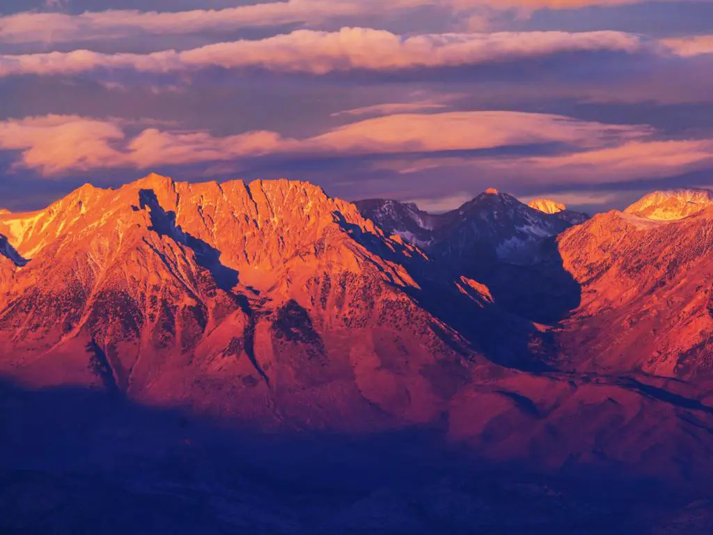 Montañas de Sierra Nevada, EE.UU. tomadas al atardecer con las montañas rojas en el fondo y un cielo espectacular arriba. 
