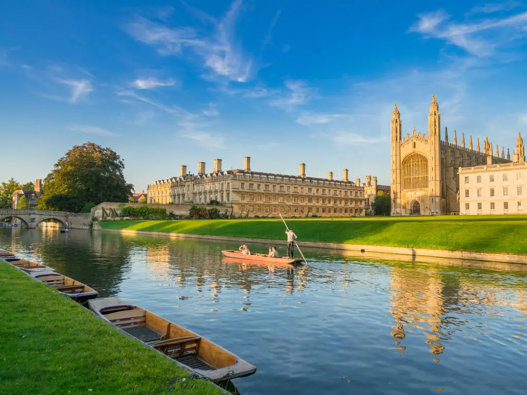 Cambridge, Reino Unido, con una hermosa vista de la universidad en Cambridge con gente jugando en la leva del río en un día soleado.