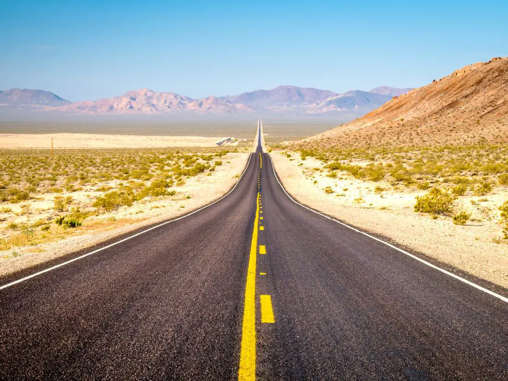 Camino que se extiende en la distancia a través del Parque Nacional Death Valley en California.